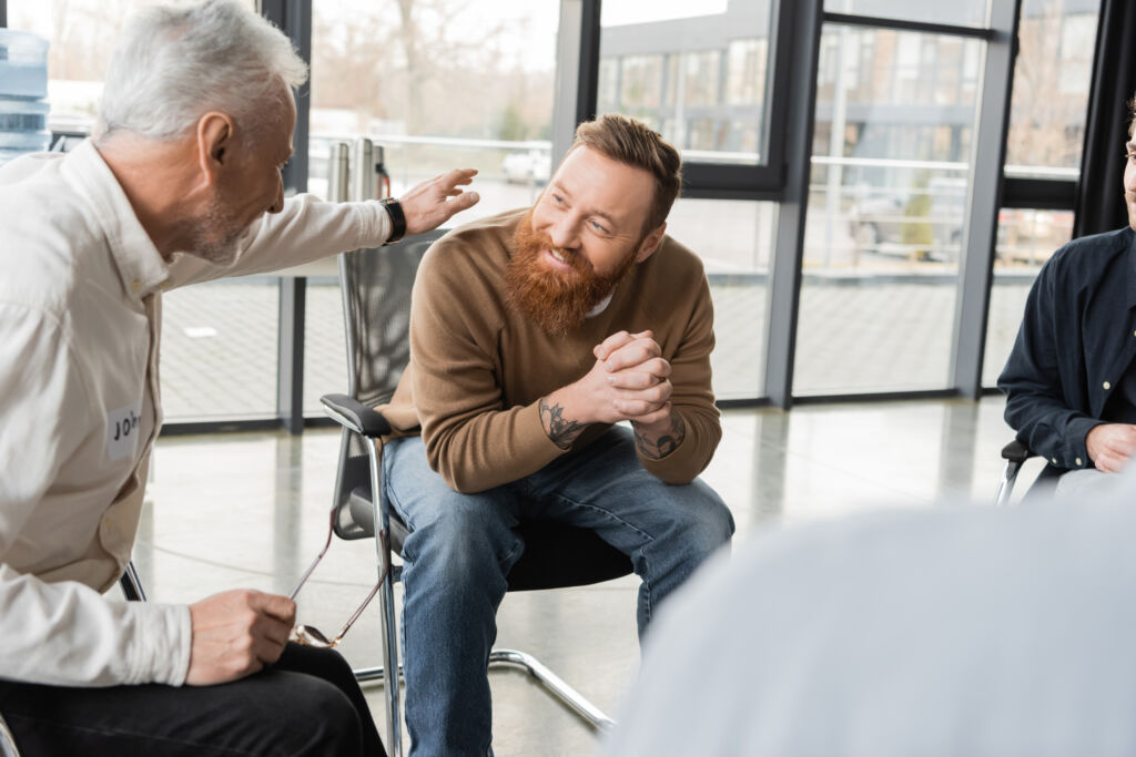 A group of men in a support group meeting for addiction.