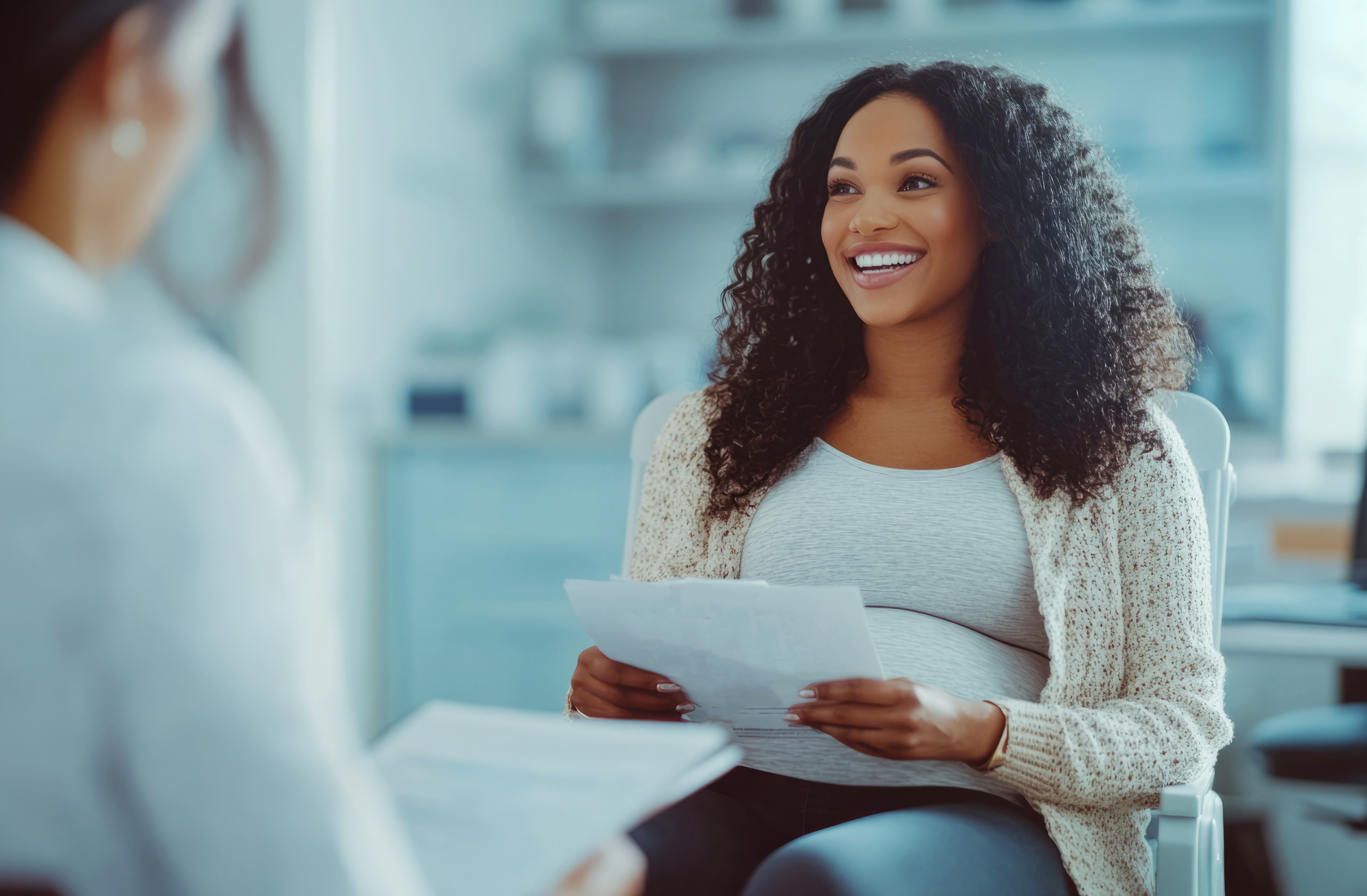 Pregnant woman holding document Benefits of Addiction Treatment and MAT During Pregnancy