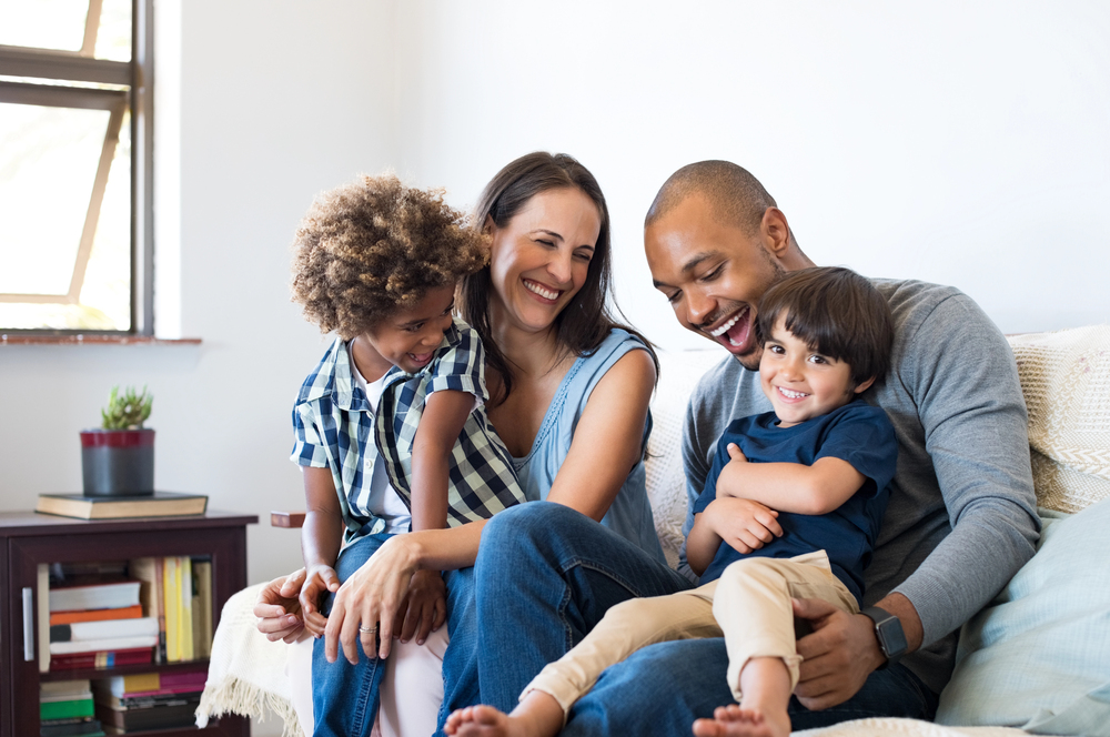 High-functioning addicts maintain seemingly normal lives - A happy man with his family having fun at home.