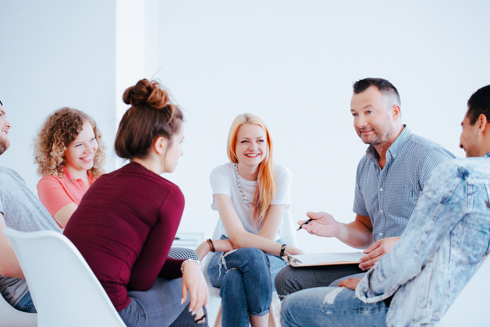 A group therapy session for prescription opioid addiction treatment.