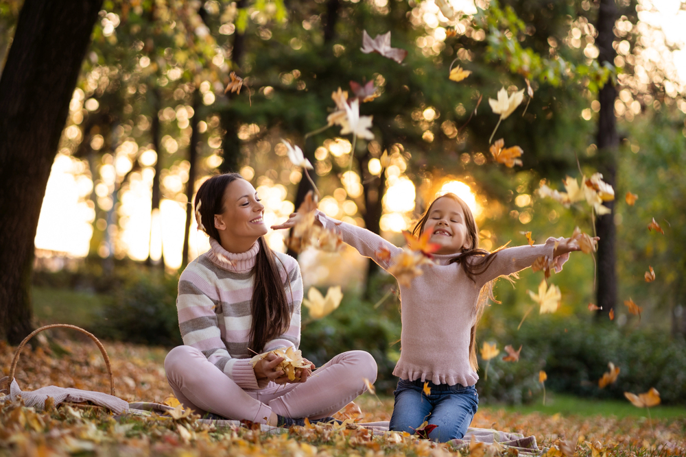 A stolen shot of mother and child enjoying autumn, representing a new life after a drug abuse treatment.